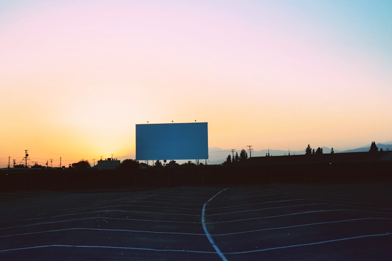 Drive-in movie screen at sunset