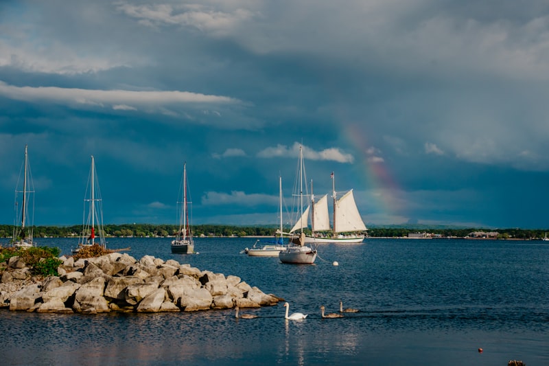 Sailboats and a rainbow over a Lake Michigan harbor